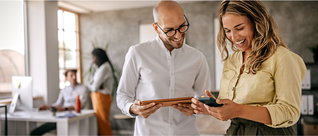 Two persons looking at a tablet