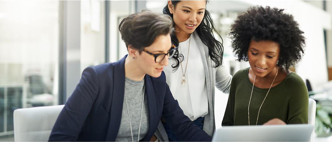 A group of women looking at a computer