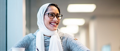 A person wearing glasses and a scarf