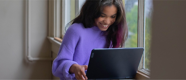 A person smiling at a computer