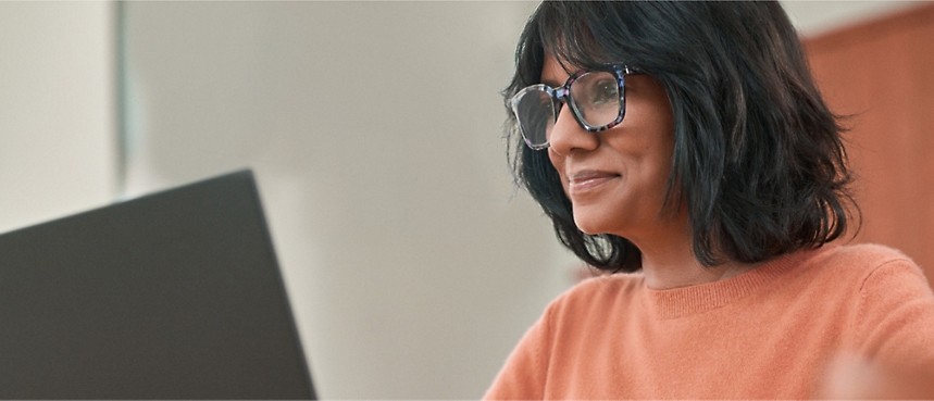 A person wearing glasses and a orange shirt