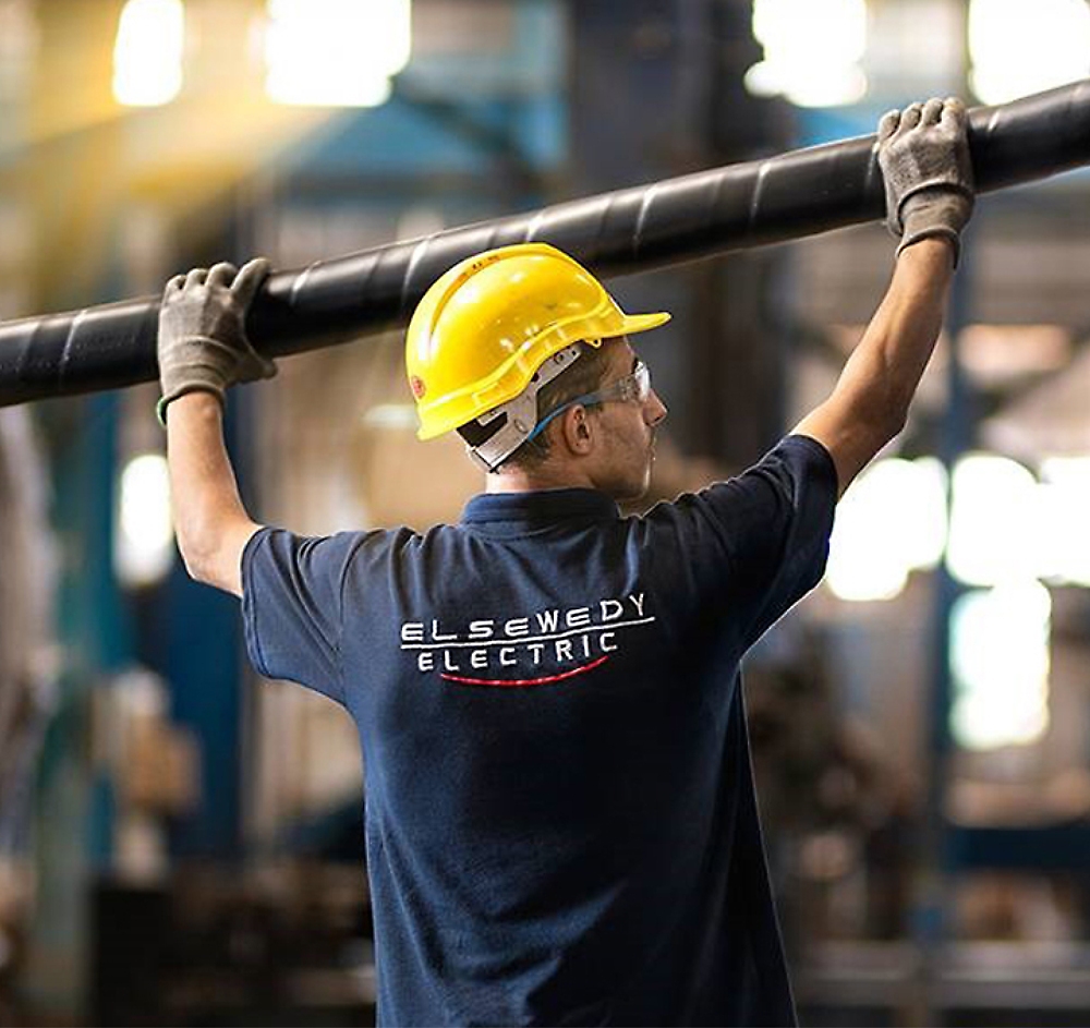 A person holding a black pipe