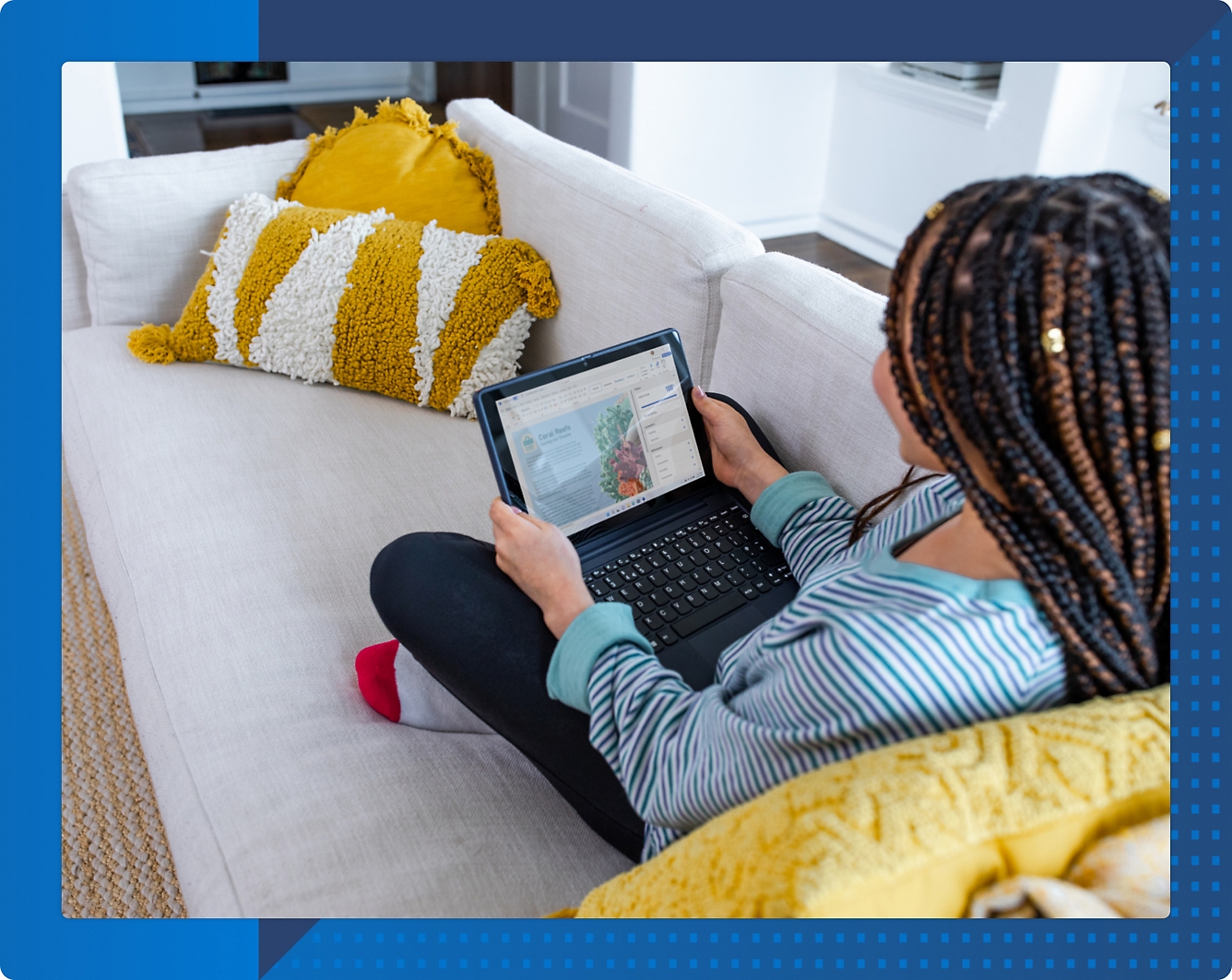 A person sitting on a couch using a computer