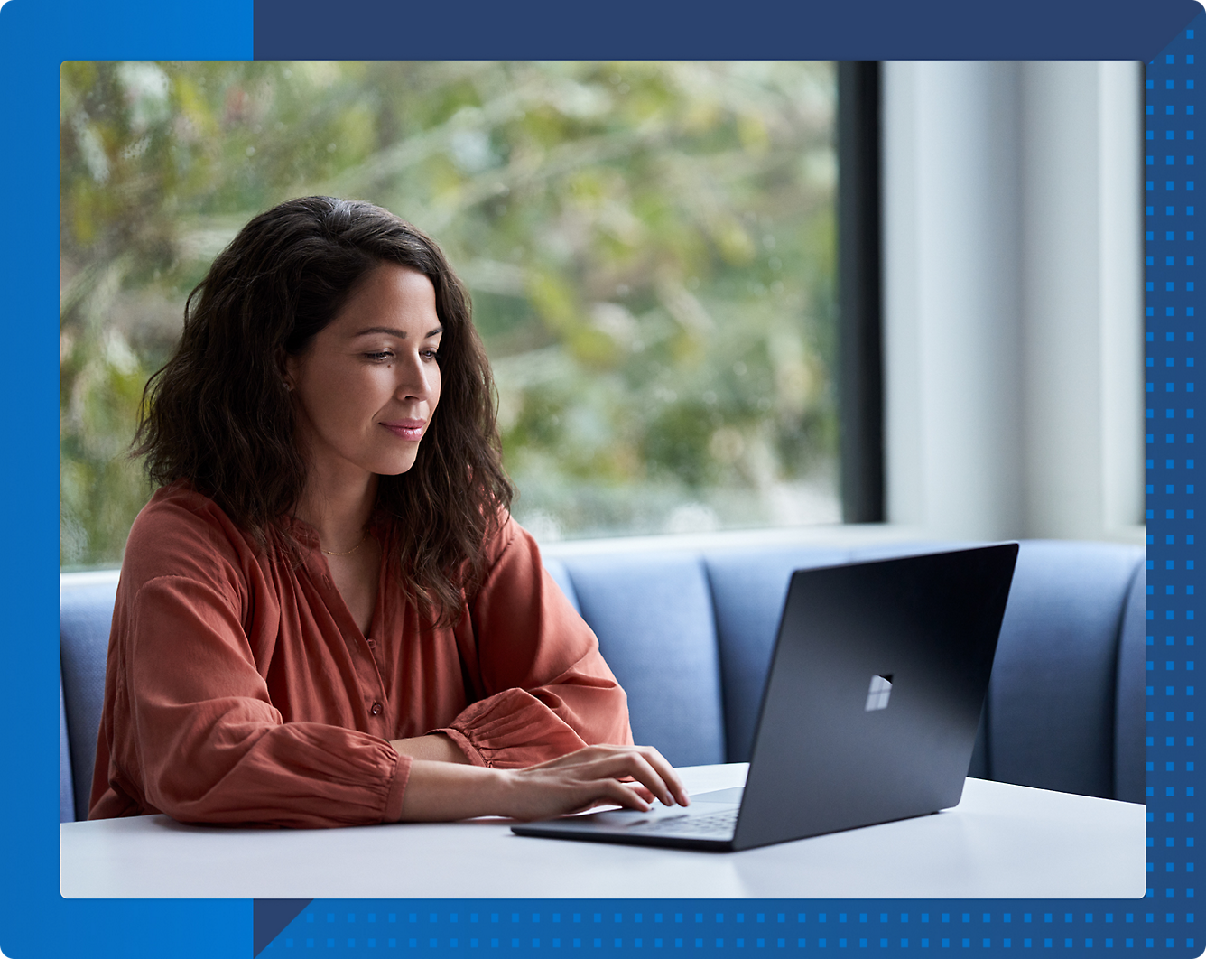 A person sitting at a table using a computer