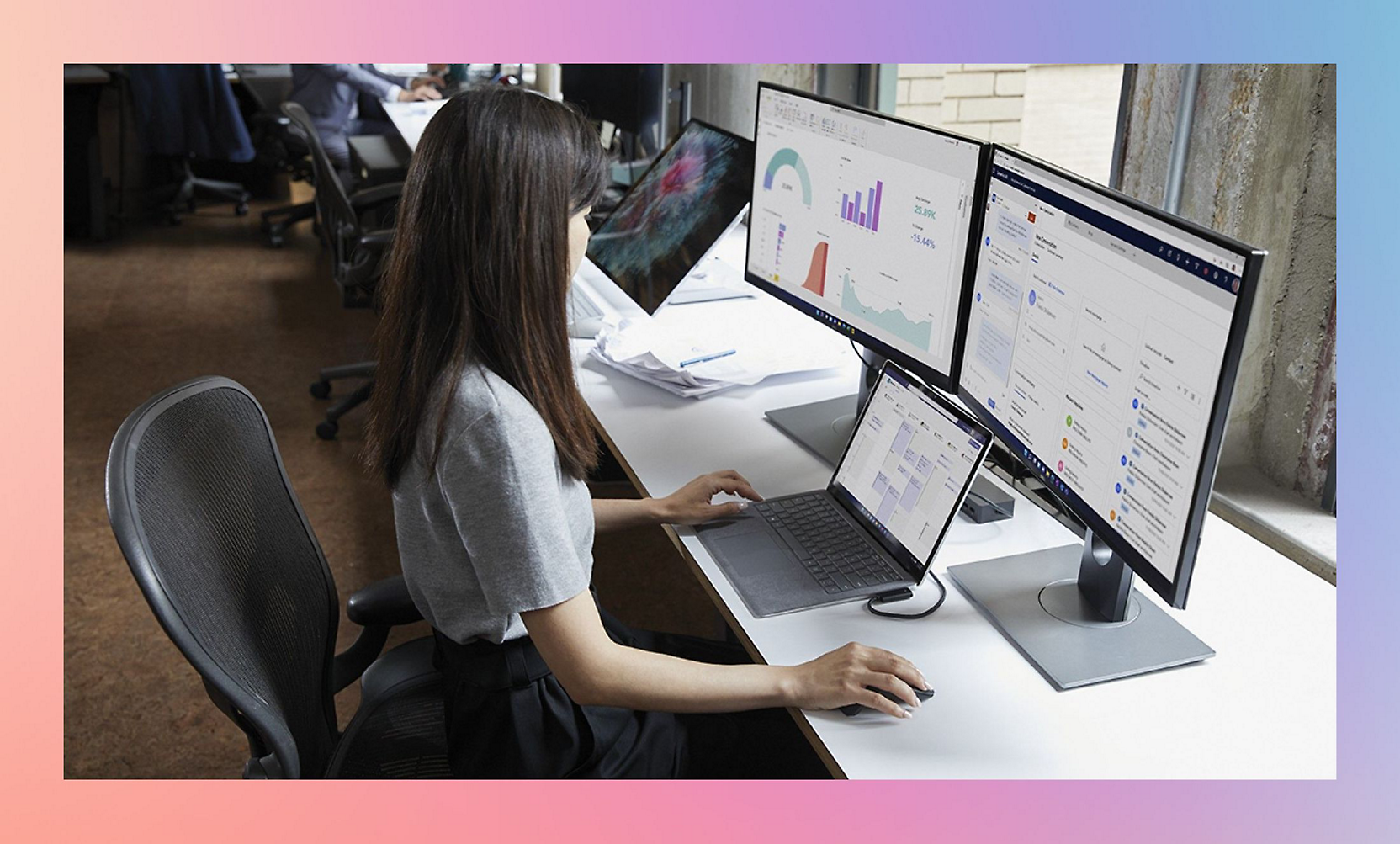 A girl working on multiple computer