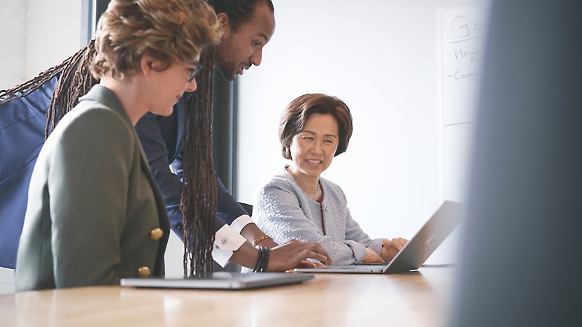 A group of people looking at a computer