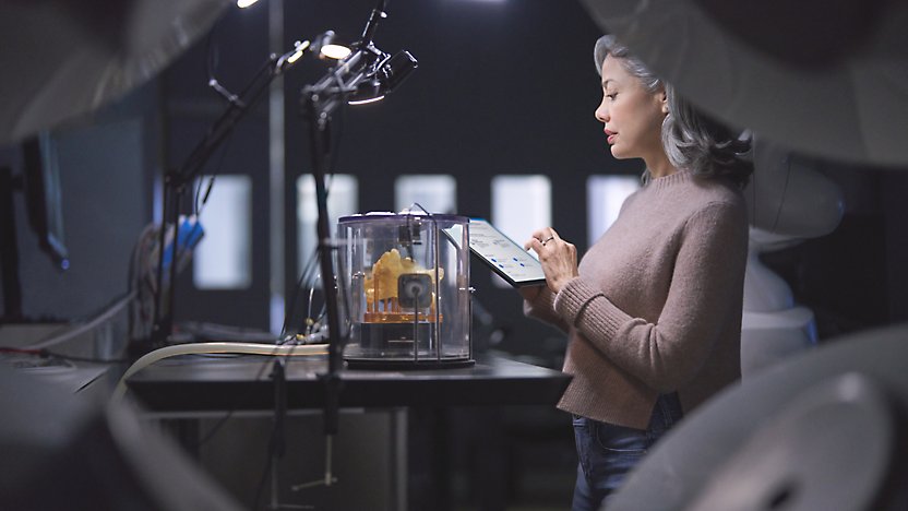 A person holding a tablet and working on it.