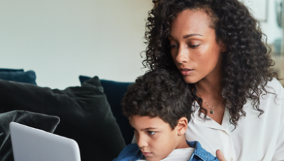 A mother and son using a laptop.