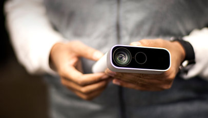 A person holding an Azure Kinect DK device.