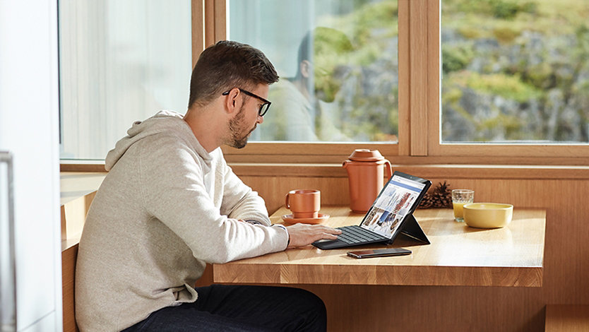 A person using Microsoft 365 on a laptop.