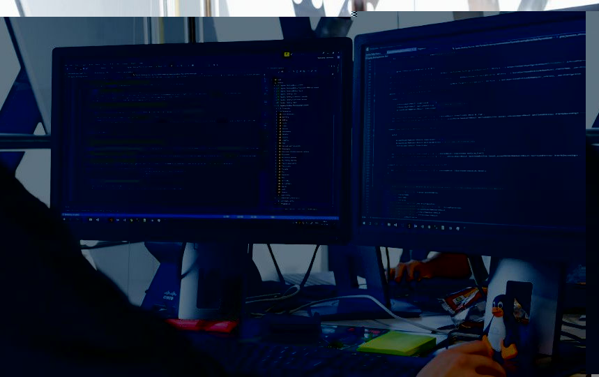 A man working on dual monitors.