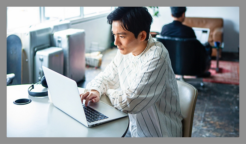 A man working with laptop in a office room