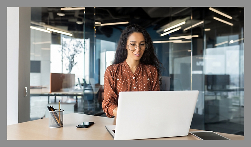 A women working with white colour laptop in a office room