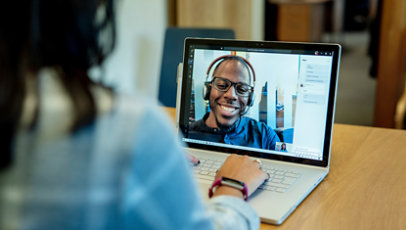 A woman using video chat software to speak with a consultant.