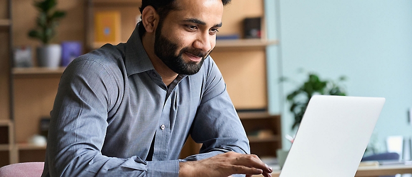 A man looking at the laptop