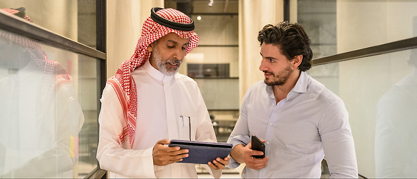 Two persons looking at a tablet