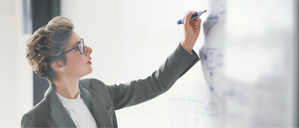 A person writing on a whiteboard