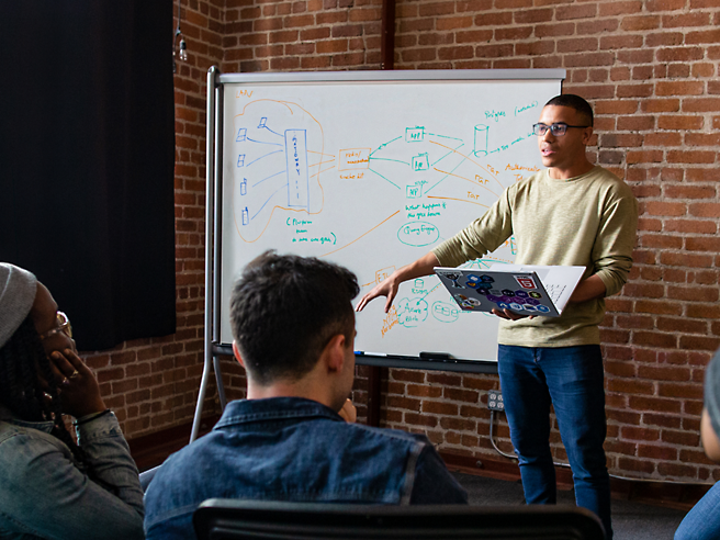 A man is giving a presentation to a group of people