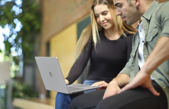 A woman looking at her Surface laptop