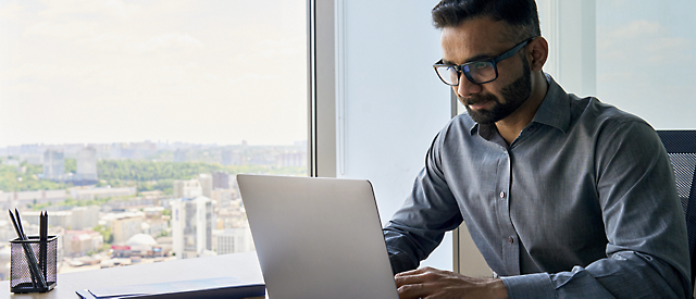 A person sitting at a desk with a computer