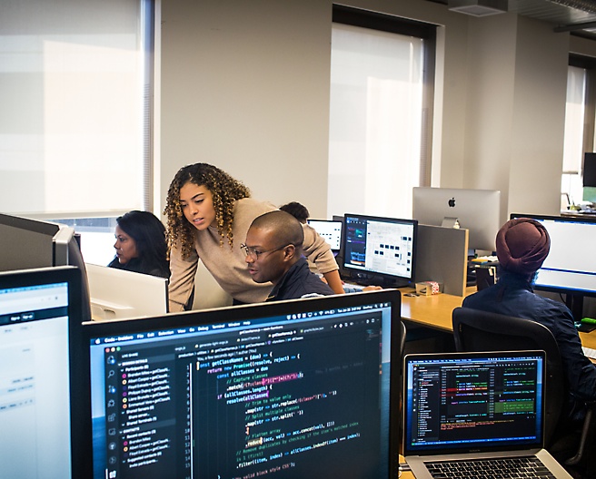 Group of people sitting in the office and working with their system