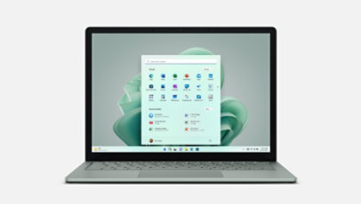 Front view of Surface Laptop 5 in Sage with a sage green blossom on the Windows 11 start screen.