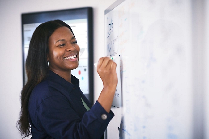 A person writing on a whiteboard