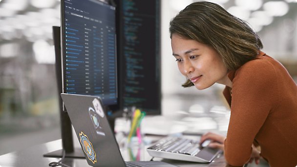 A person sitting on the chair and working with laptop