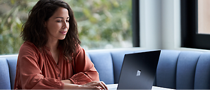 A person sitting at a table using a computer