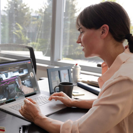 Women at a desk looking at a laptop using technology