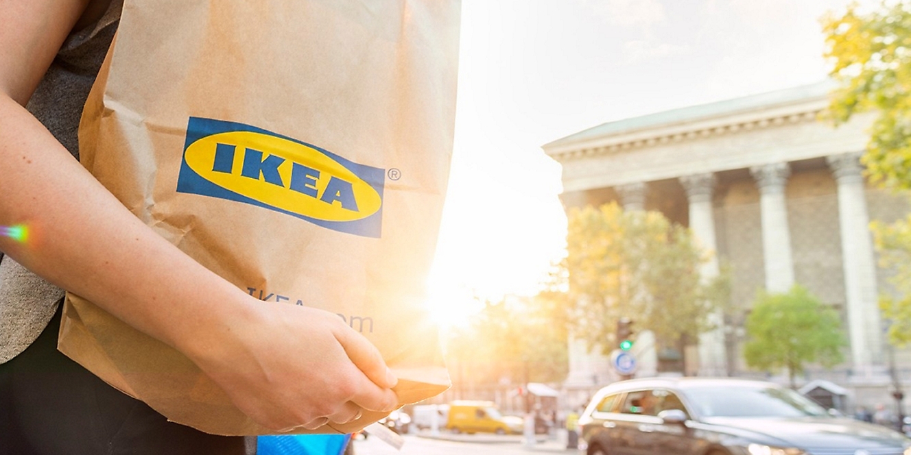 Person holding an Ikea bag walking down the street