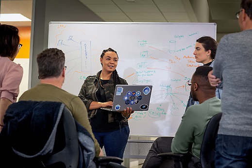 People discussing the presentation with text written over white board