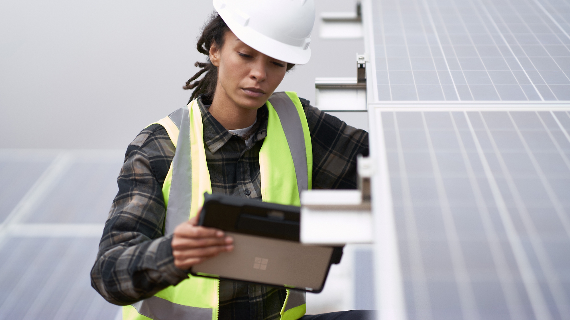 A person in a safety vest and white hard hat