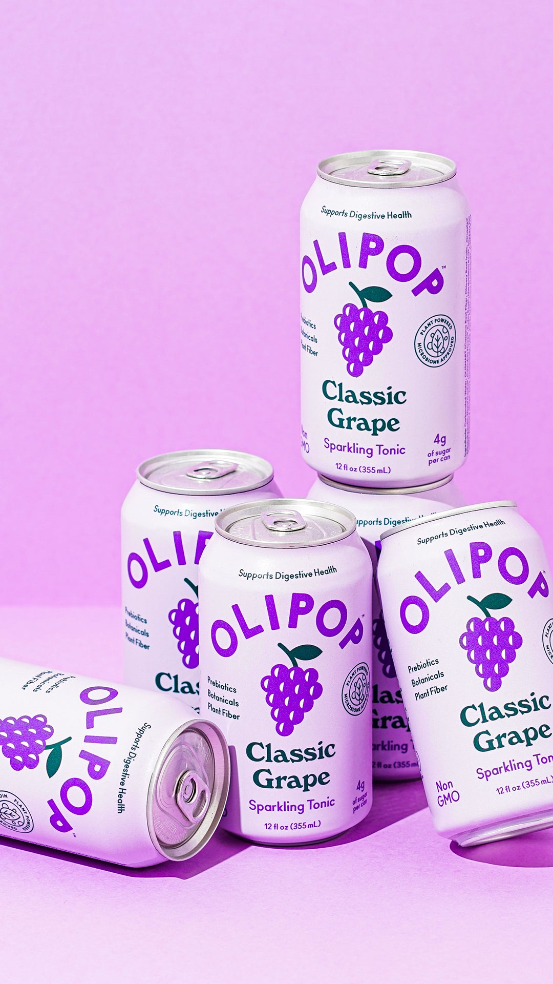 A stack of Grape Flavor Olipop cans, backdropped by a light purple background. 