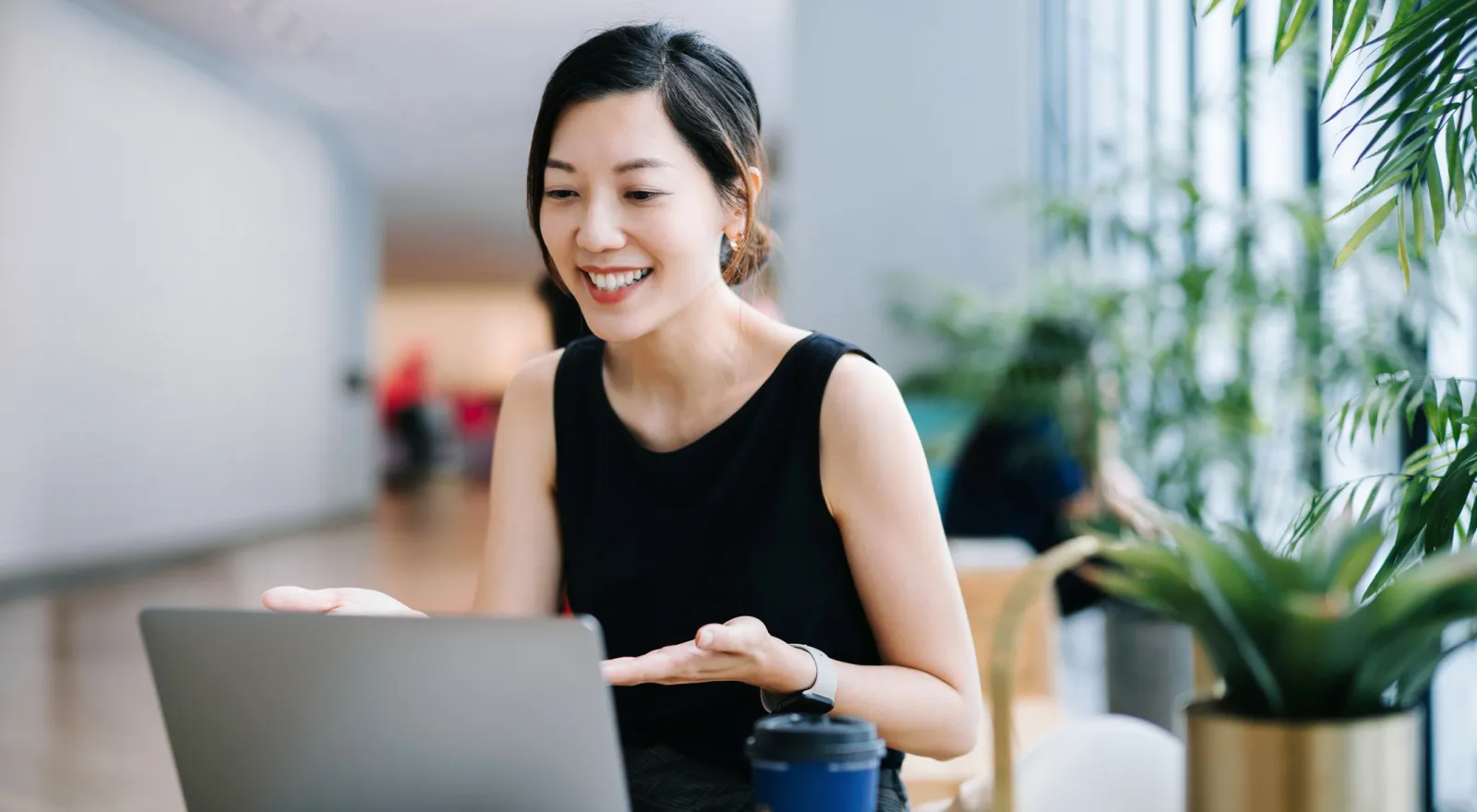 Woman smiling and looking at a computer screen