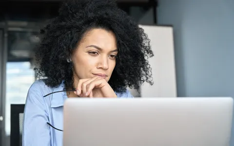 a woman looking at a computer