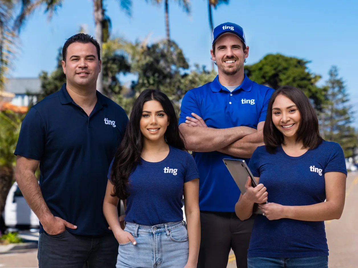 Members of the Ting team smile for the camera in Southern California with palm trees in the background