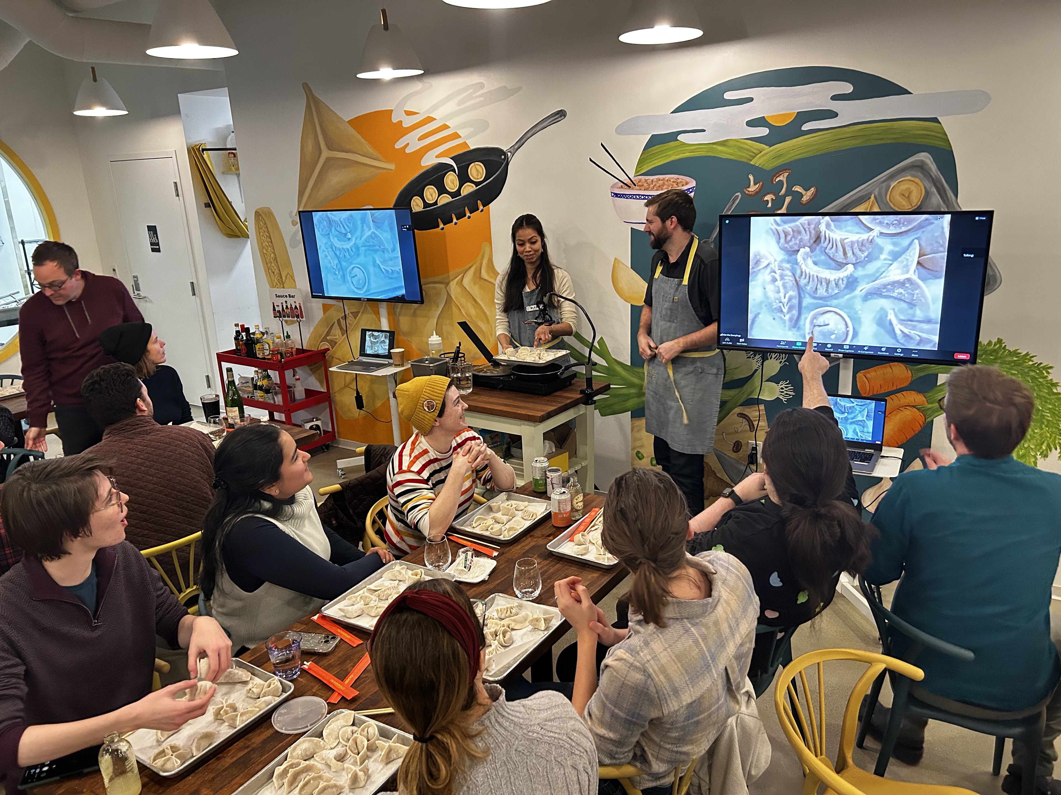 A picture of the team learning how to make dumplings.