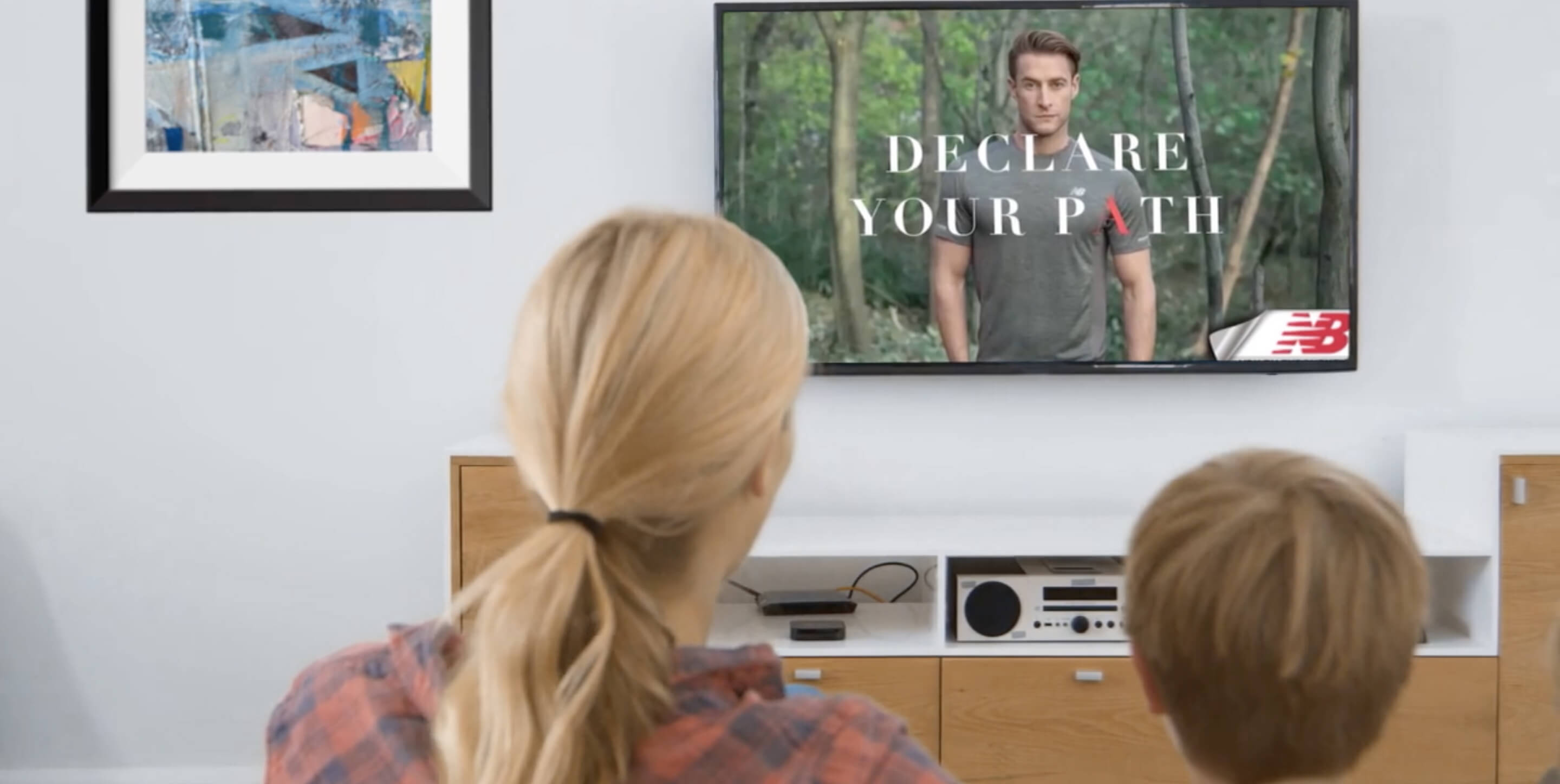 woman and child watching an ad on the tv