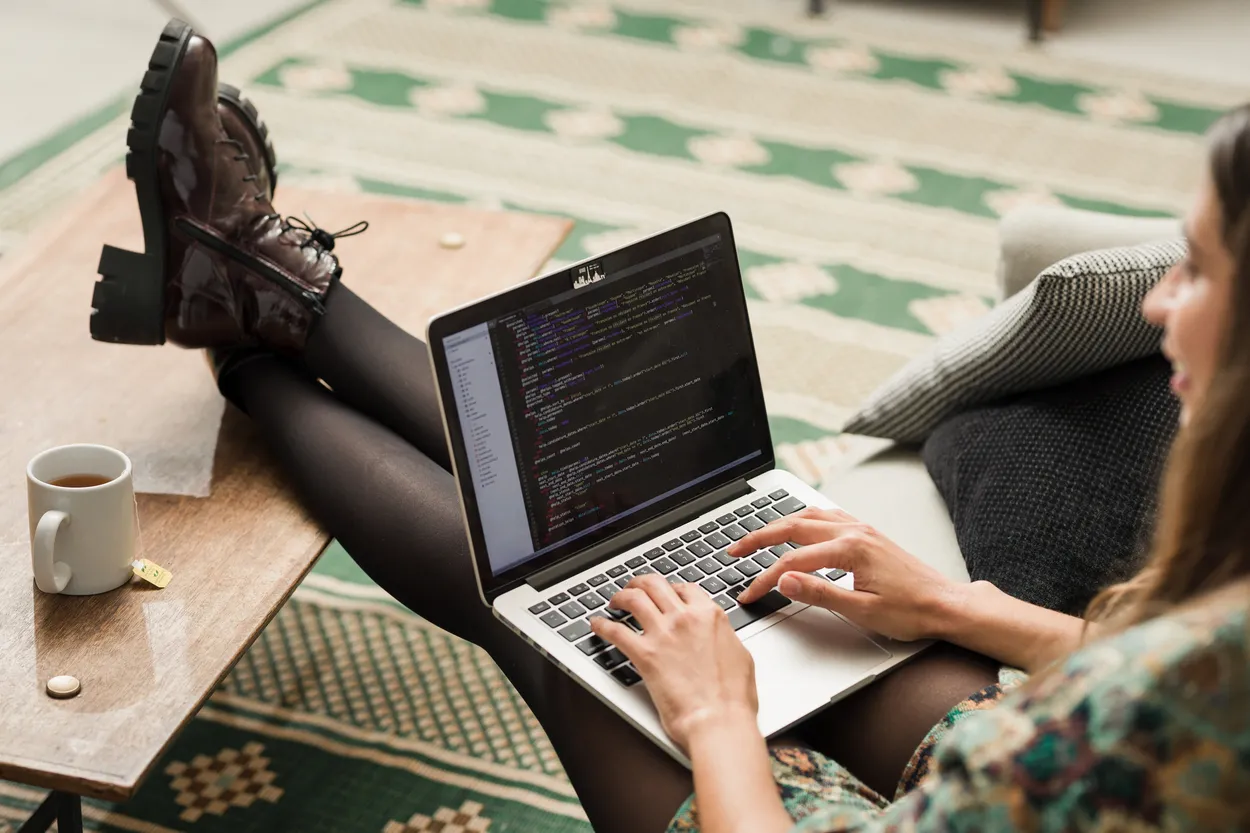 A woman coding on her laptop