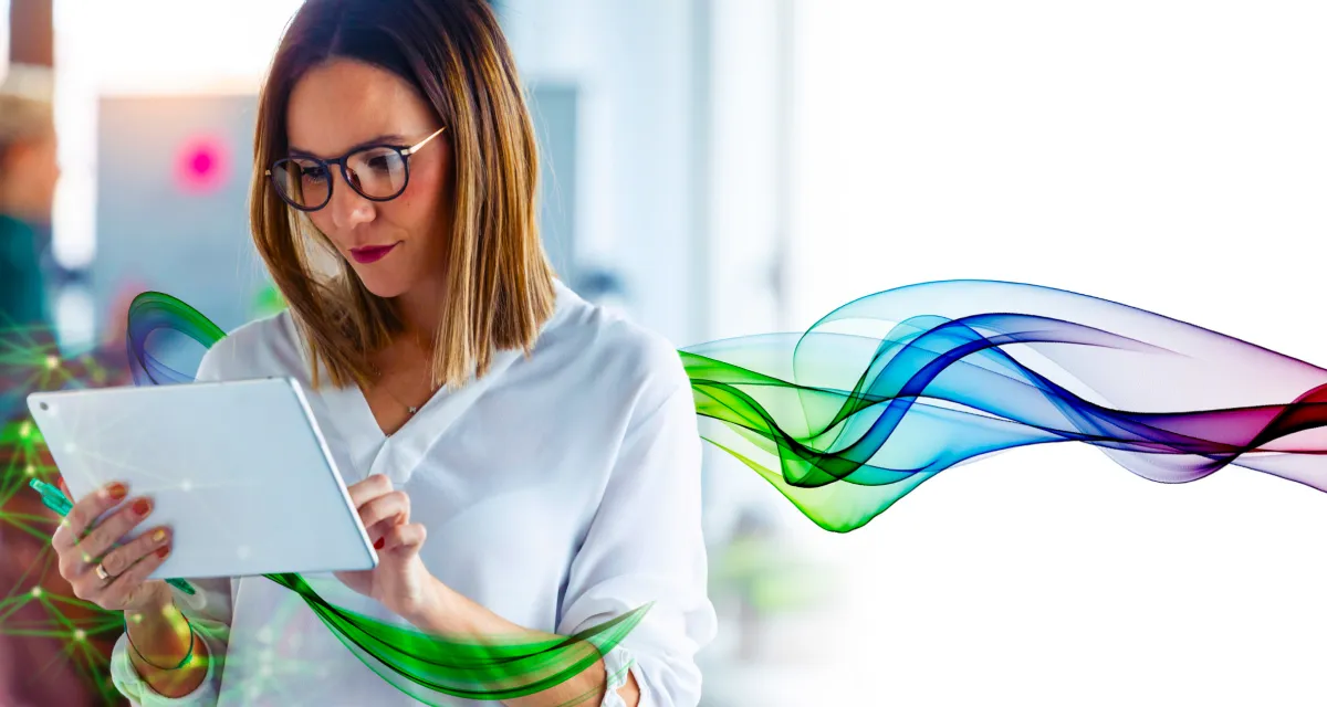 Businesswoman standing and looking at digital tablet