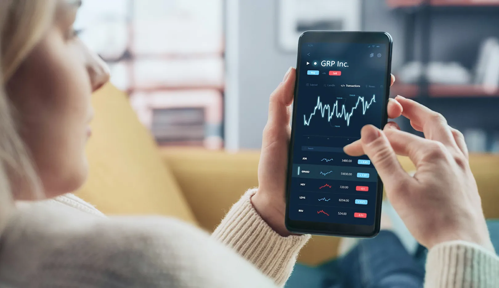 Woman looking at a financial app on her smartphone