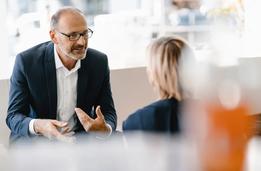 a man and a woman sitting at a table talking