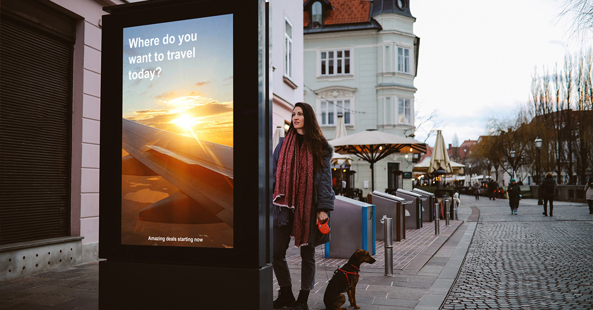 Women standing by a sign that reads "where do you want to go today?"