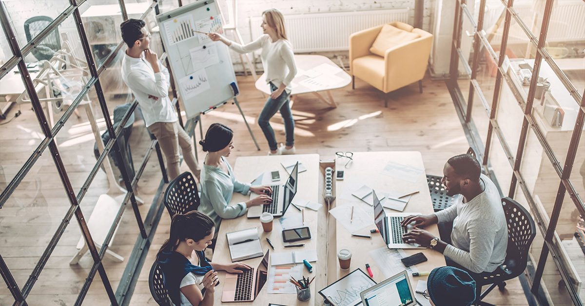 Several people collaborating on a project in a modern office space.