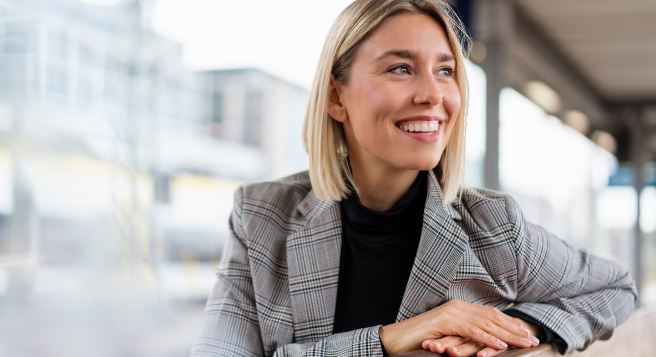 Women in modern office smiling and looking at a coworker