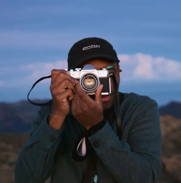 Freelance photographer behind a camera lens in outdoor landscape