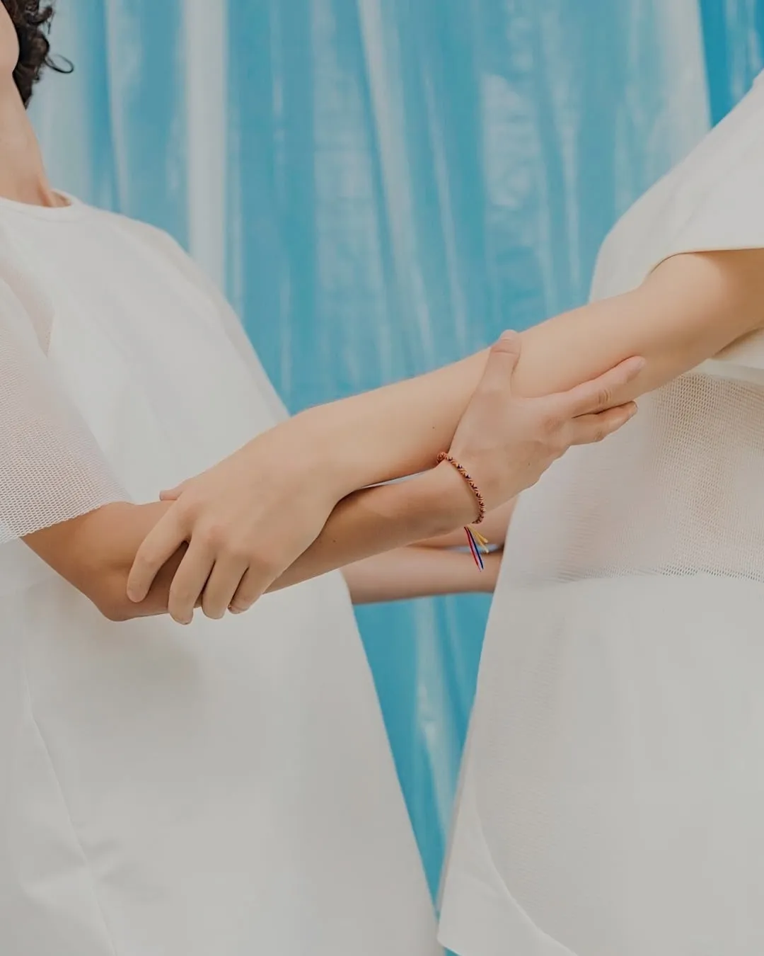 Close up of two people holding each other's elbows by professional photographer Cody Guilfoyle