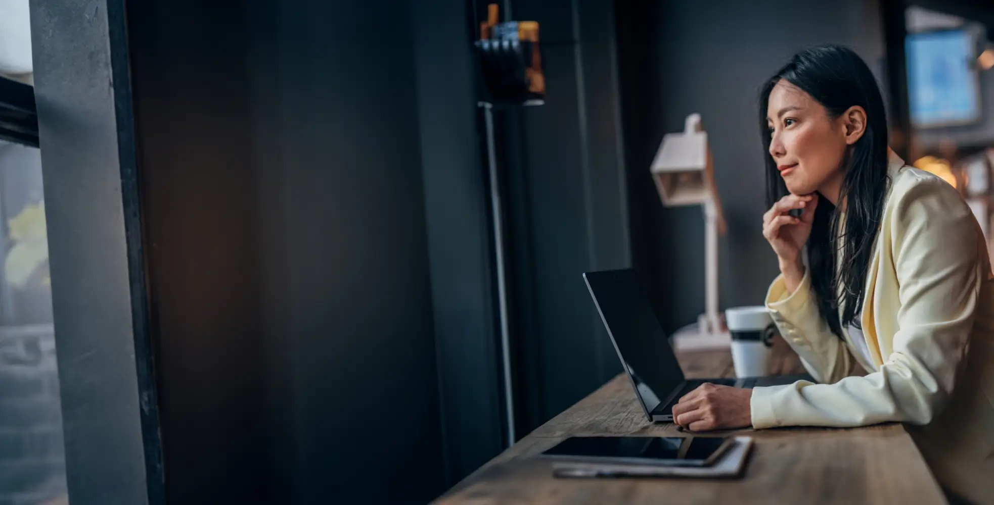 Thoughtful person working remotely with laptop 