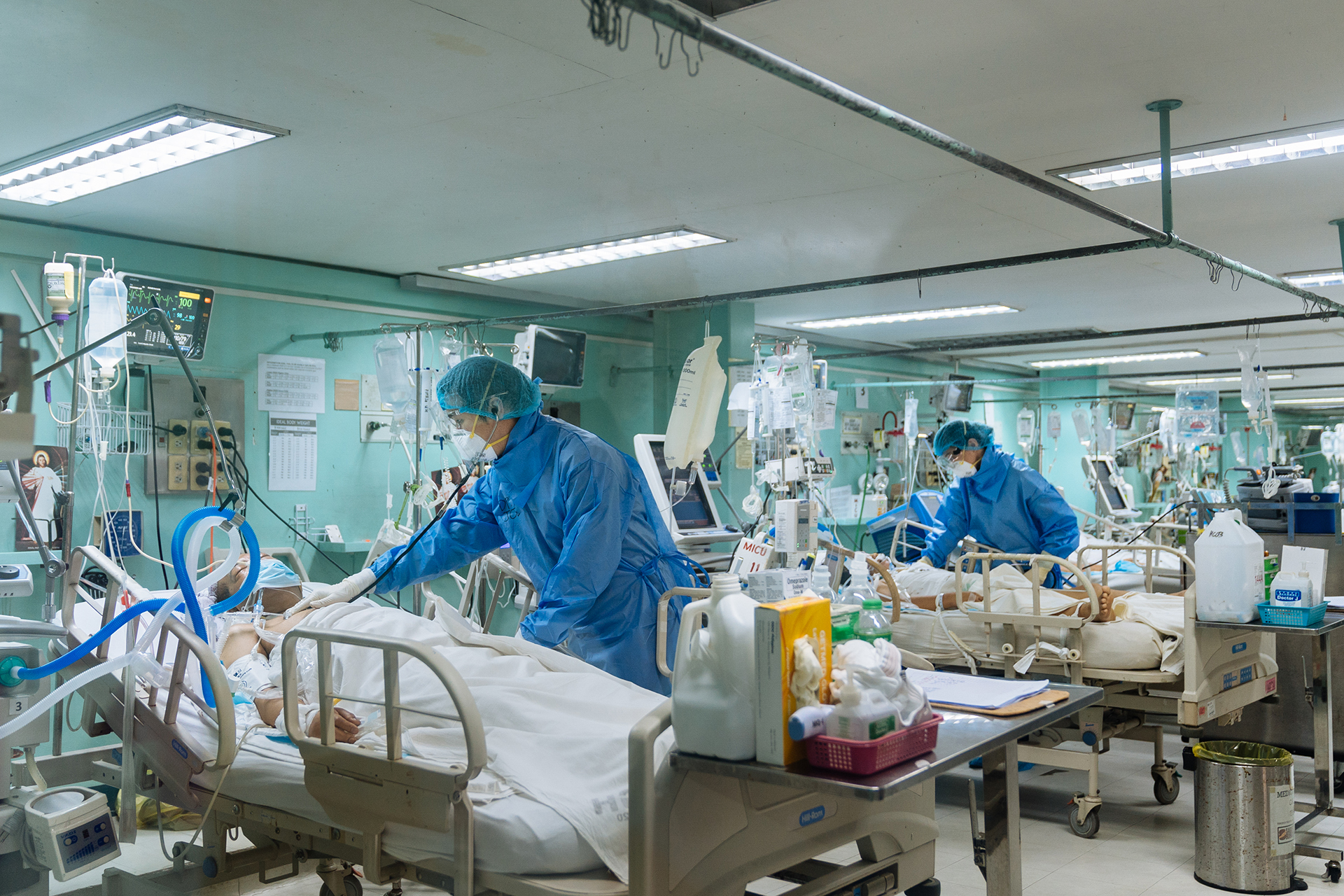 Doctors attend to patients in the COVID-19 ICU of the Philippine General Hospital in Manila. They are among the first Filipinos to be vaccinated against COVID-19 in the country